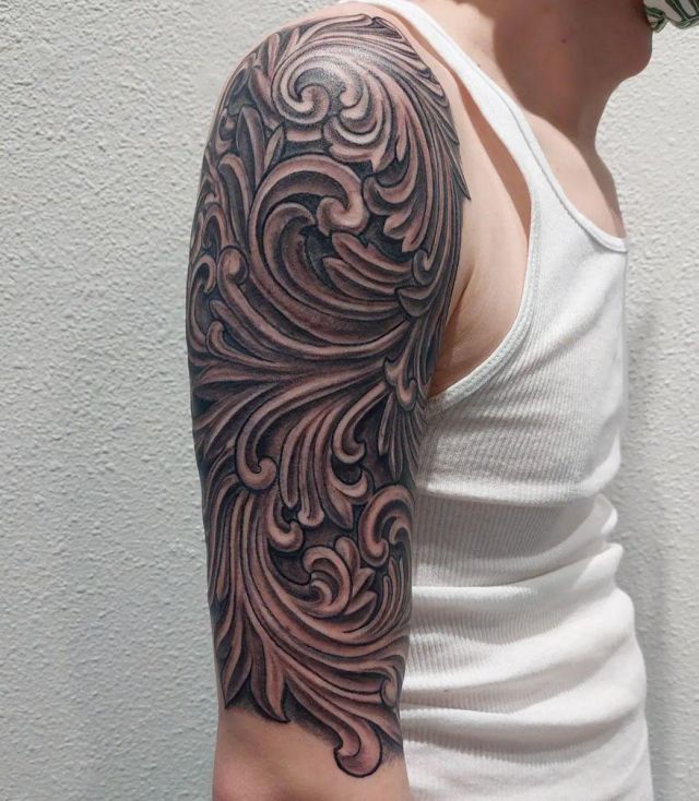 Elegant Wood Carving Tattoo on Upper Arm