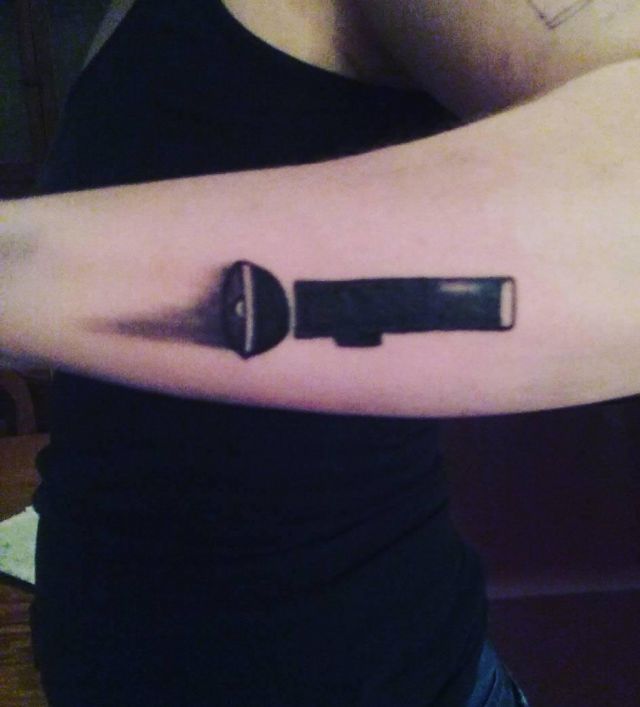 Simple Black Flashlight Tattoo On Arm