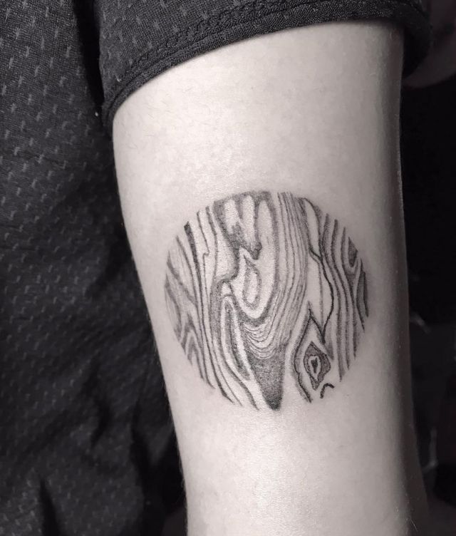 Circular Wood Grain Tattoo on Arm