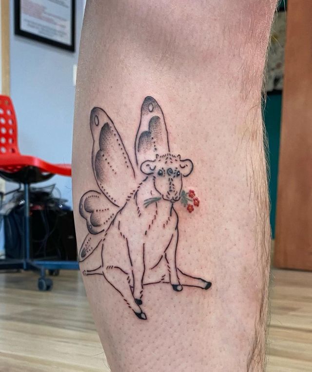 Fairy Cow Tattoo With Flowers In His Mouth