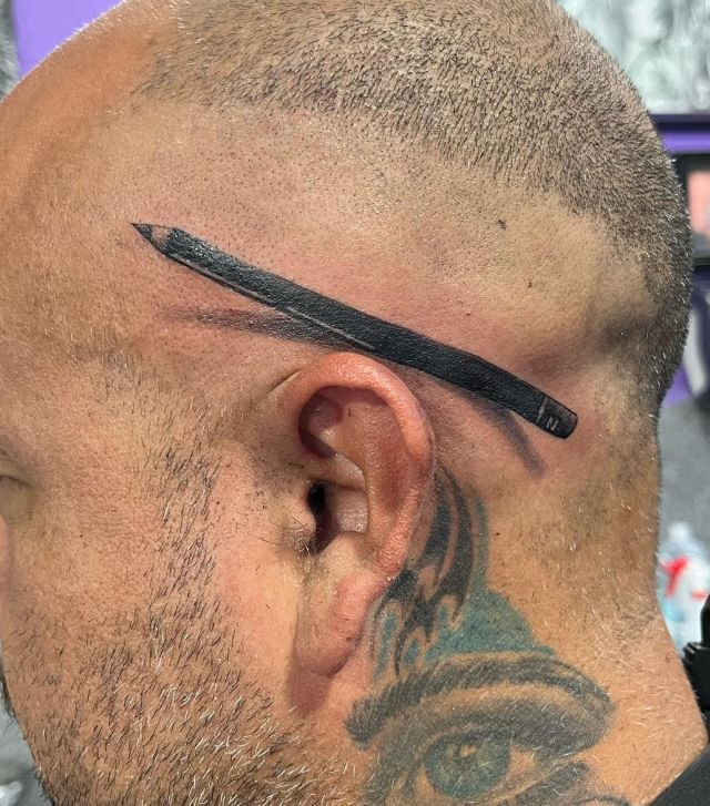 Black Pencil Behind the Ear Tattoo