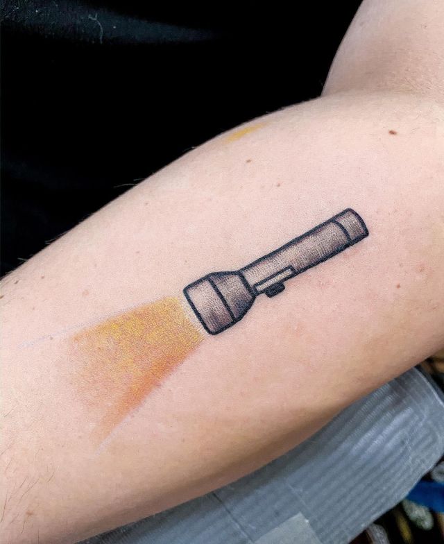 Flashlight Tattoo With Yellow Light