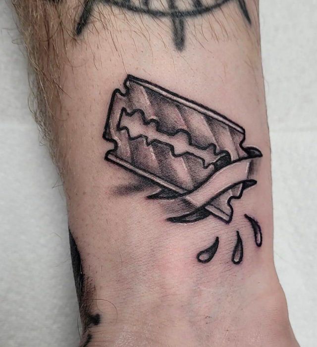 Realistic Razor Blade Tattoo on Arm