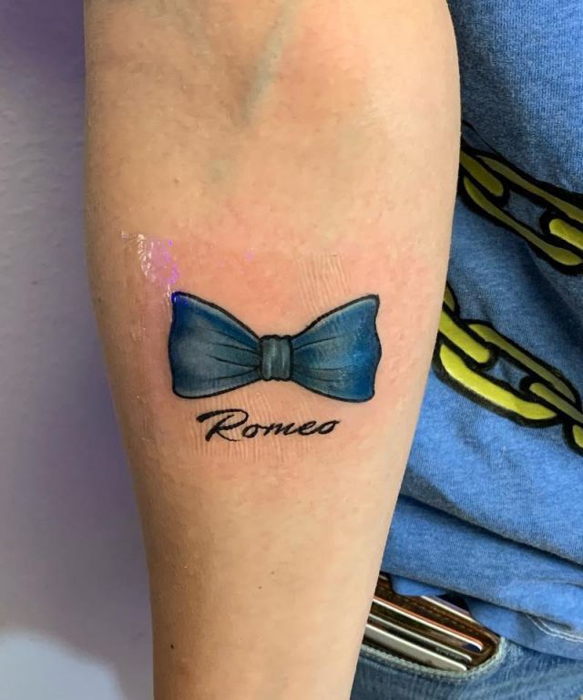 Elegant Blue Bow Tie Tattoo on Arm