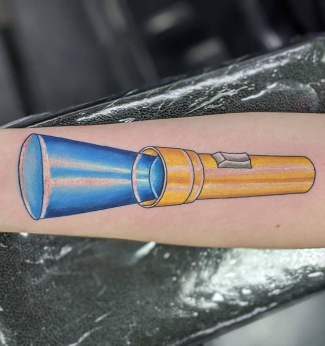 Yellow Flashlight Tattoo With Blue Light