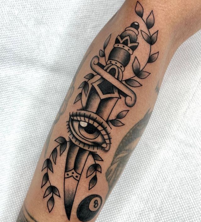 Unique Dagger Eye Tattoo with Branches on Arm