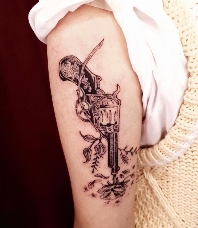 Pretty Revolver Tattoo with Flowers on Upper arm