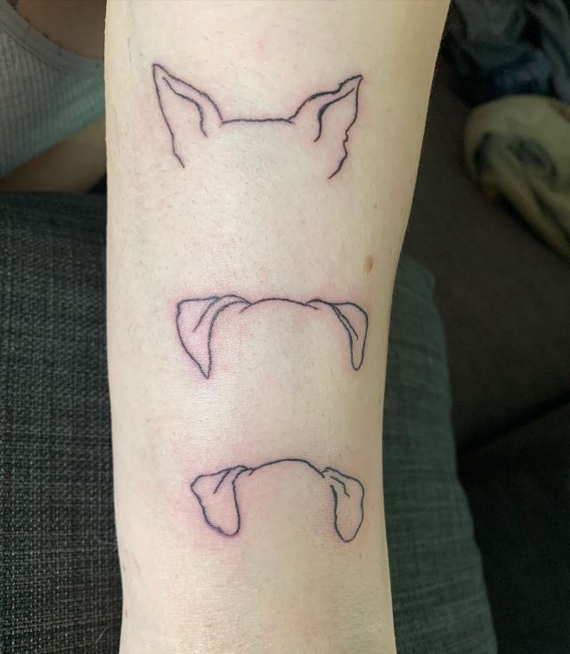 Three Dog Ear Tattoo on Arm