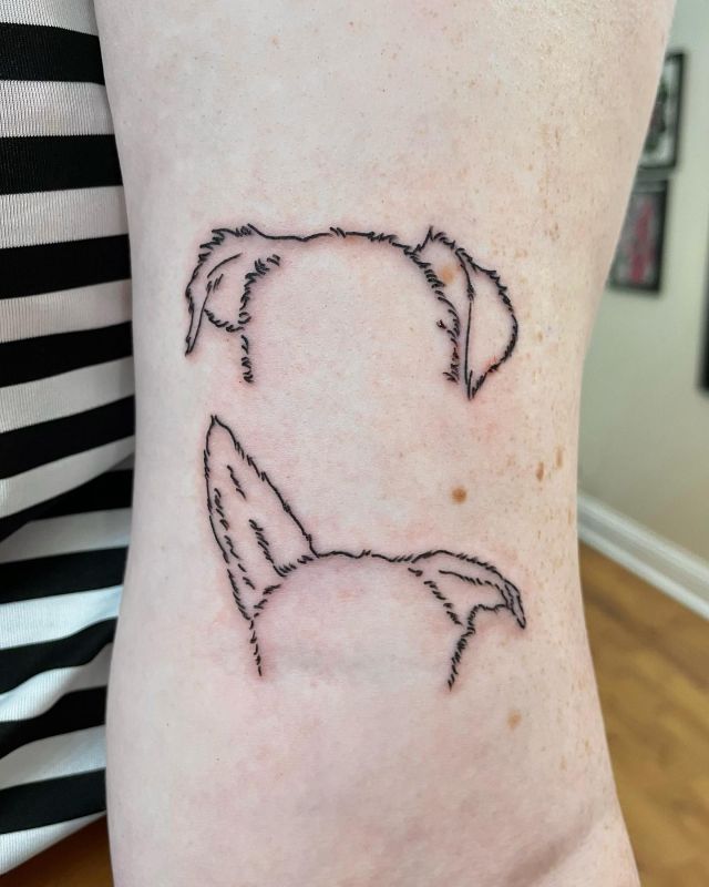 Two Dog Ear Tattoo on Upper Arm<
