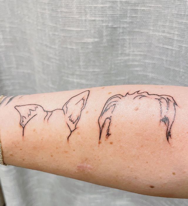 Elegant Two Dog Ear Tattoo on Forearm