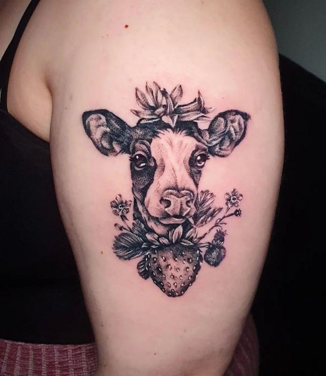 Black Strawberry Cow Tattoo on Upper Arm