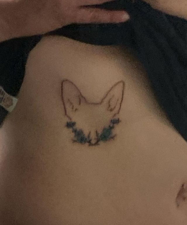 Cute Dog Ear Tattoo on Chest