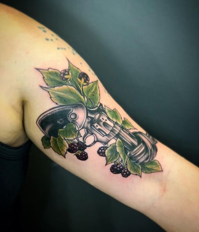 Revolver Tattoo with Raspberry on Upper Arm