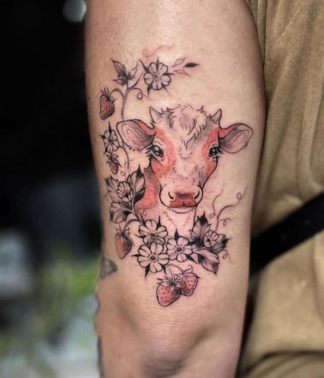 Unique Strawberry Cow Tattoo on Upper Arm
