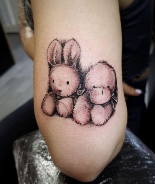 Rabbit and Dog Toy Tattoo on Arm