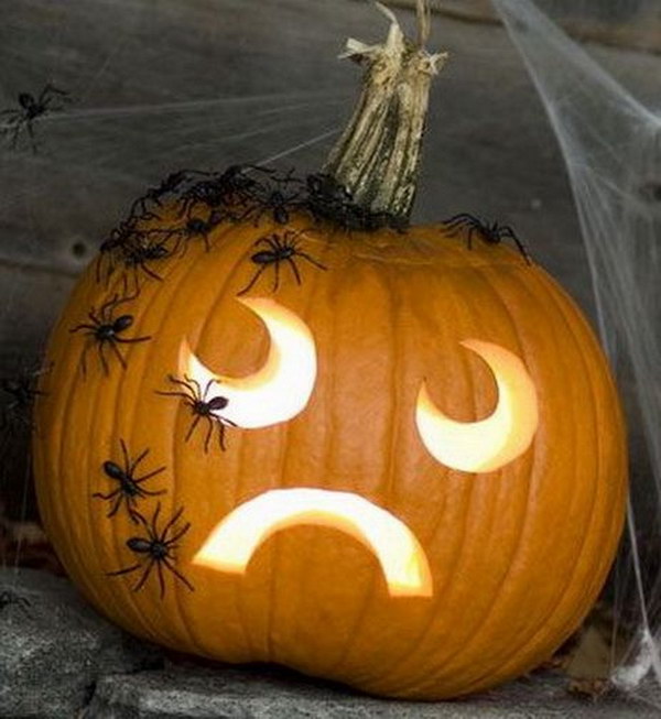 Simple Face Carved Pumpkin Decorated with Scary Spiders