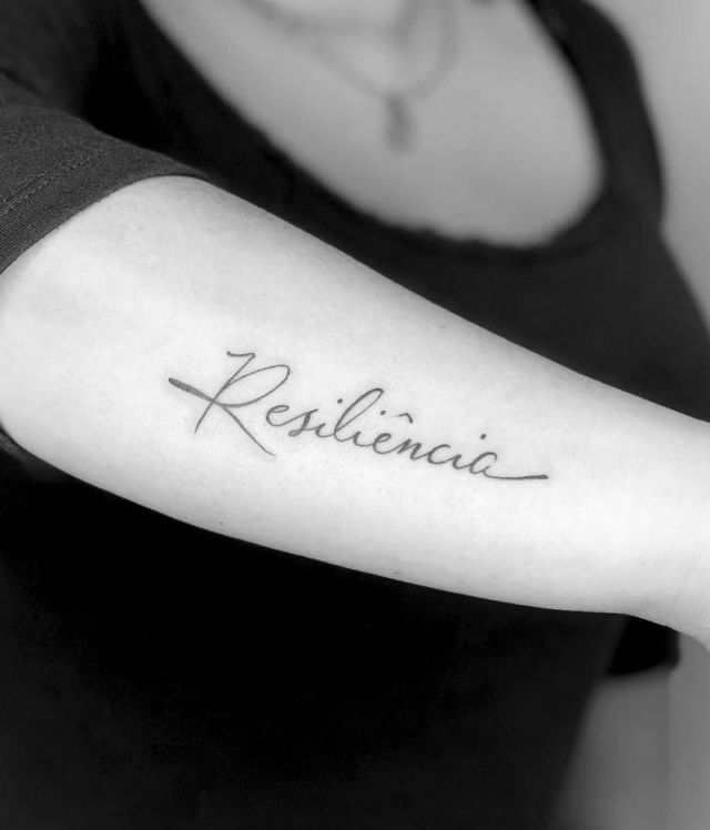 Graceful Resilience Tattoo on Forearm