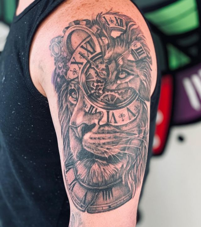 Lion and Broken Clock Tattoo on Upper Arm
