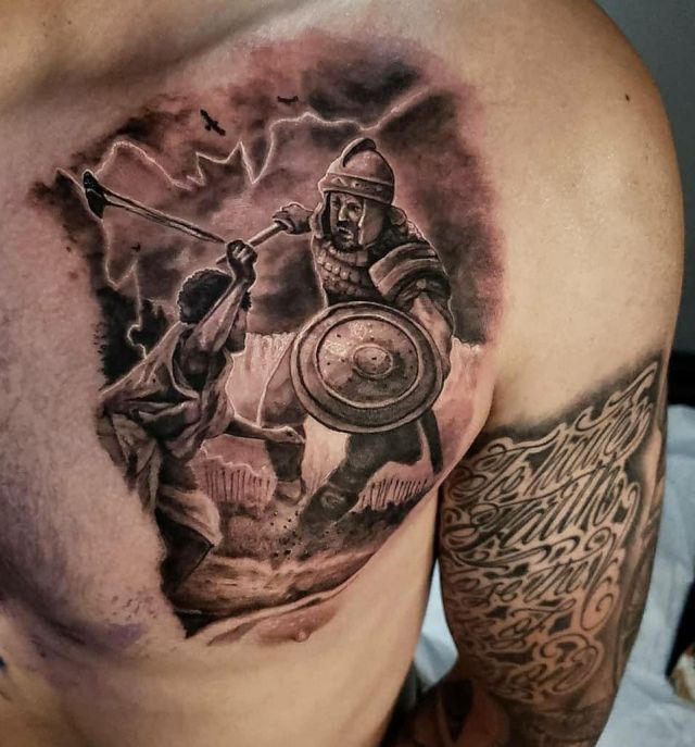 Pretty David and Goliath Tattoo on Chest