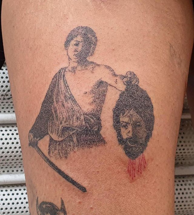 Unique David and Goliath Tattoo on Thigh
