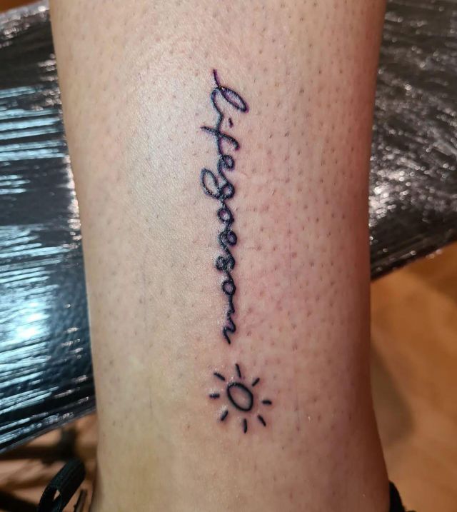 Sun and Life Goes On Tattoo on Log