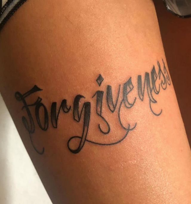 Elegant Forgiveness Tattoo on Arm